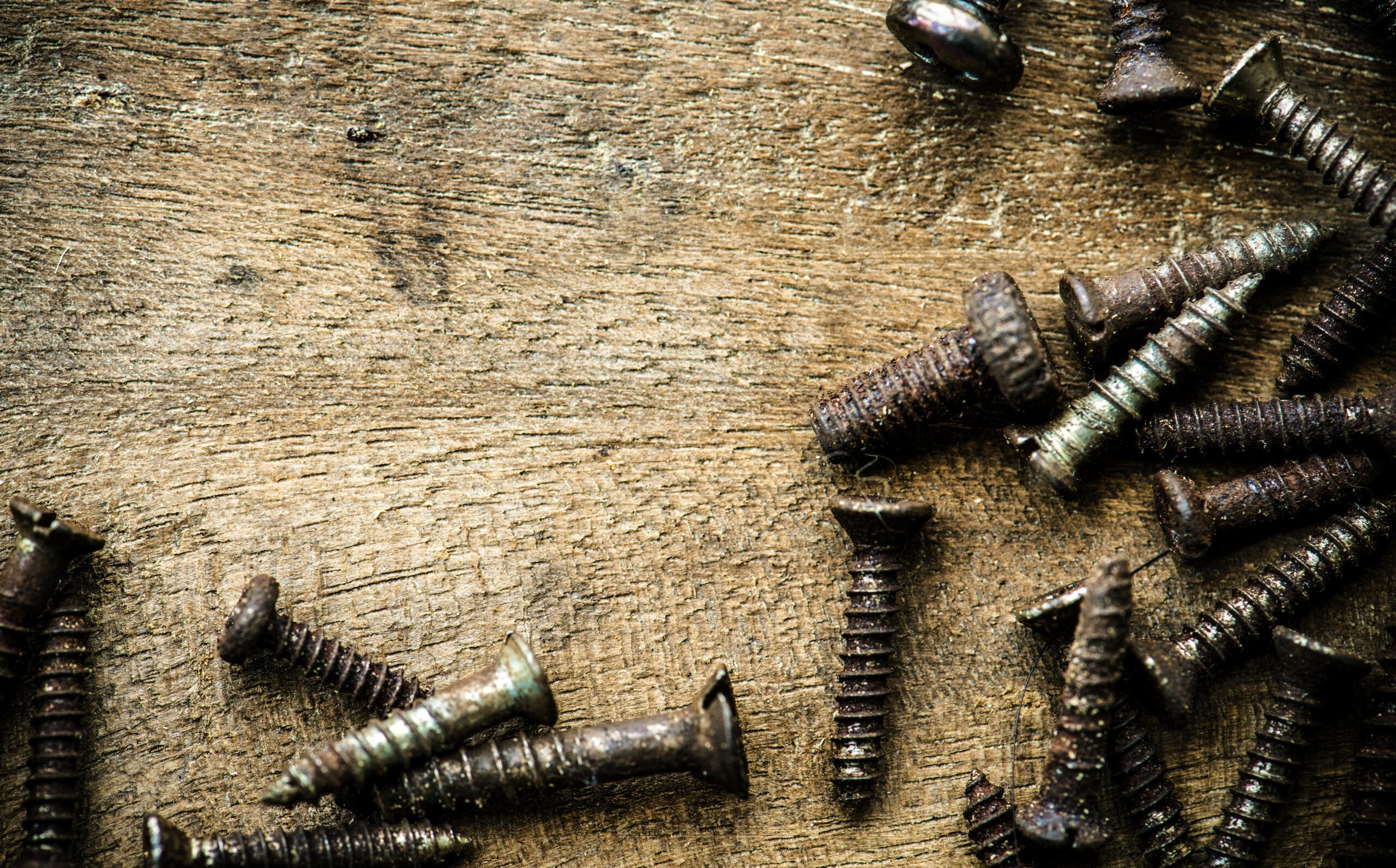 aerial-view-rustic-screws-wooden-plank-macro-scaled.jpg