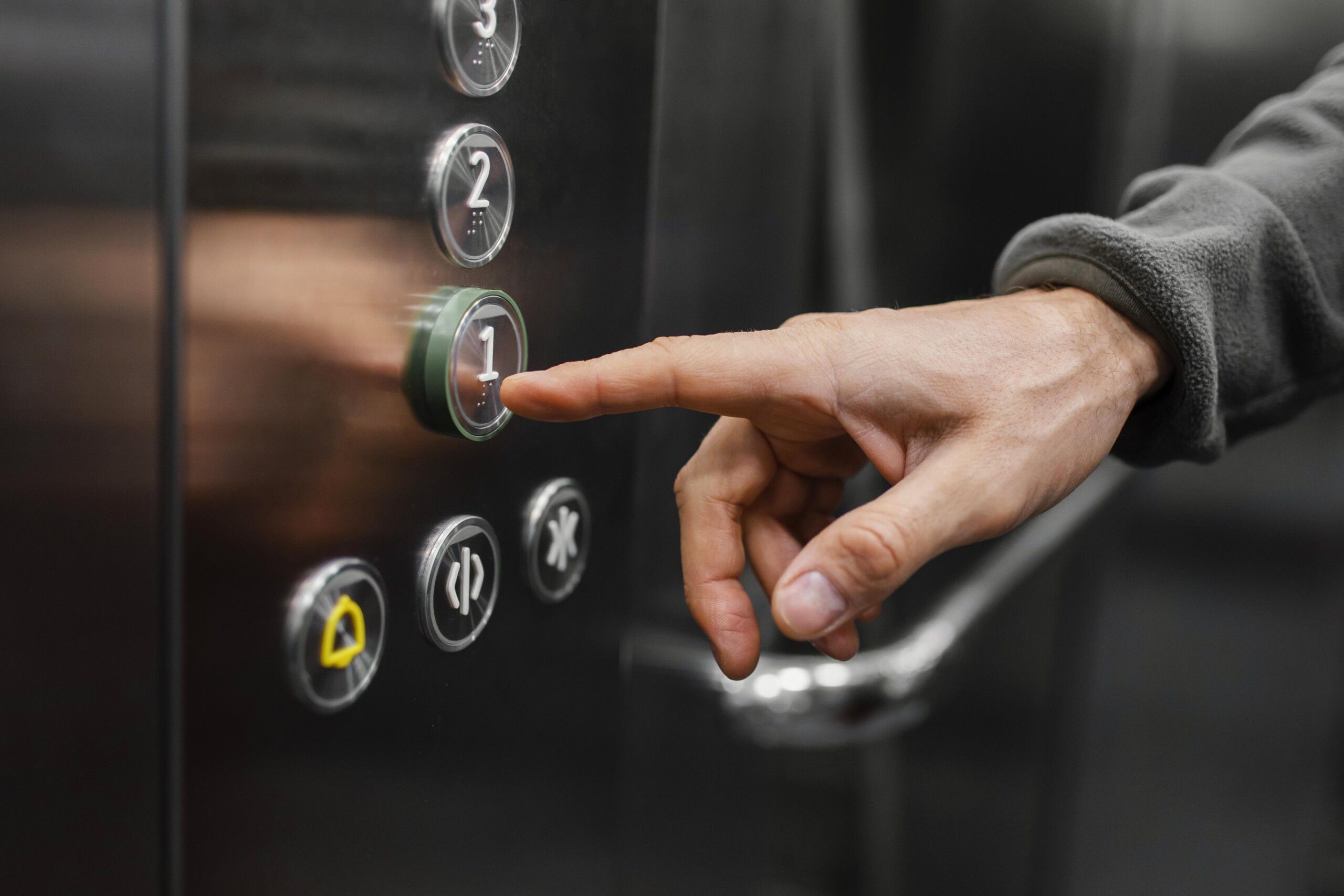 delivery-man-with-package-elevator-close-up-scaled.jpg