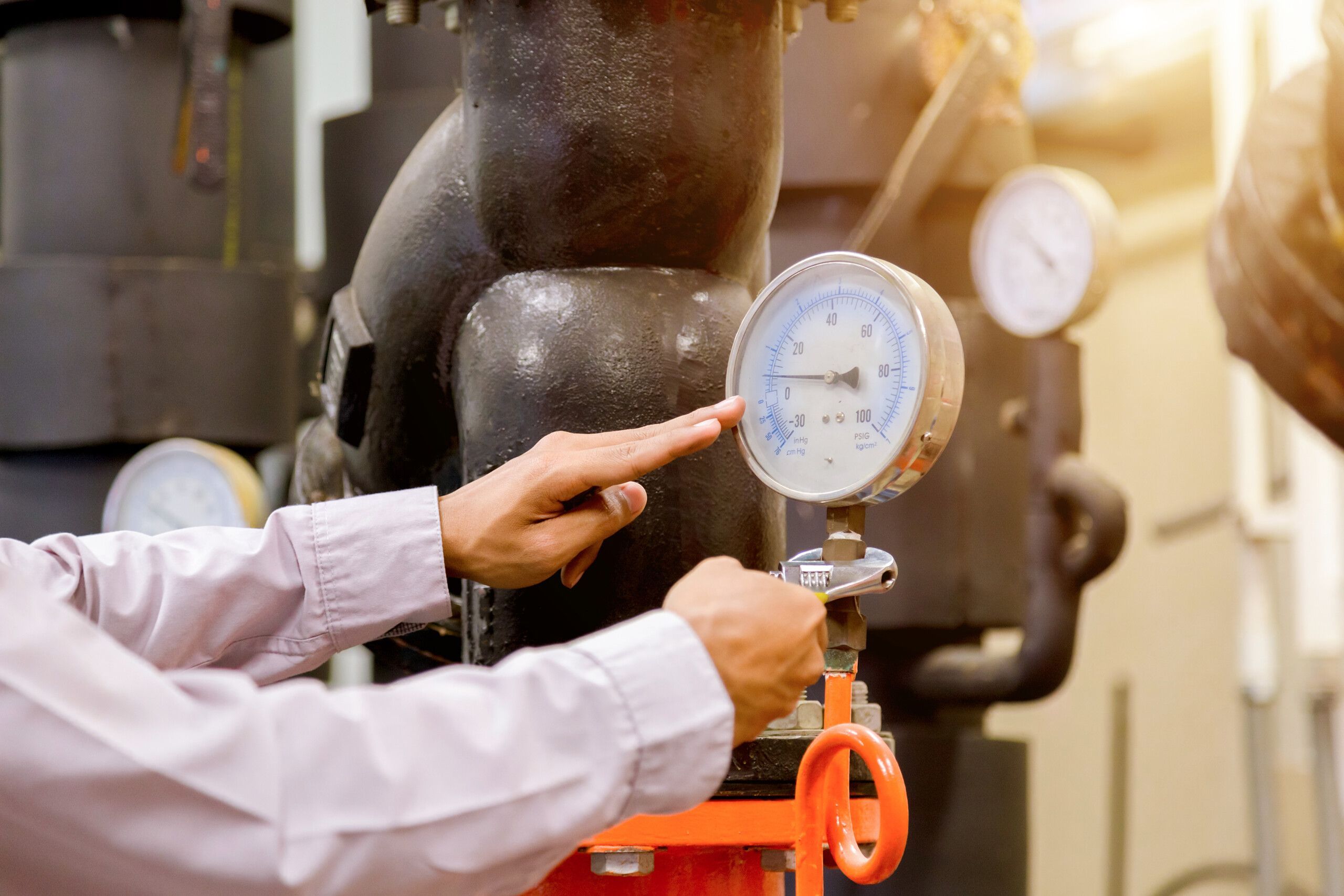 engineer-checking-condenser-water-pump-pressure-gauge-scaled.jpg