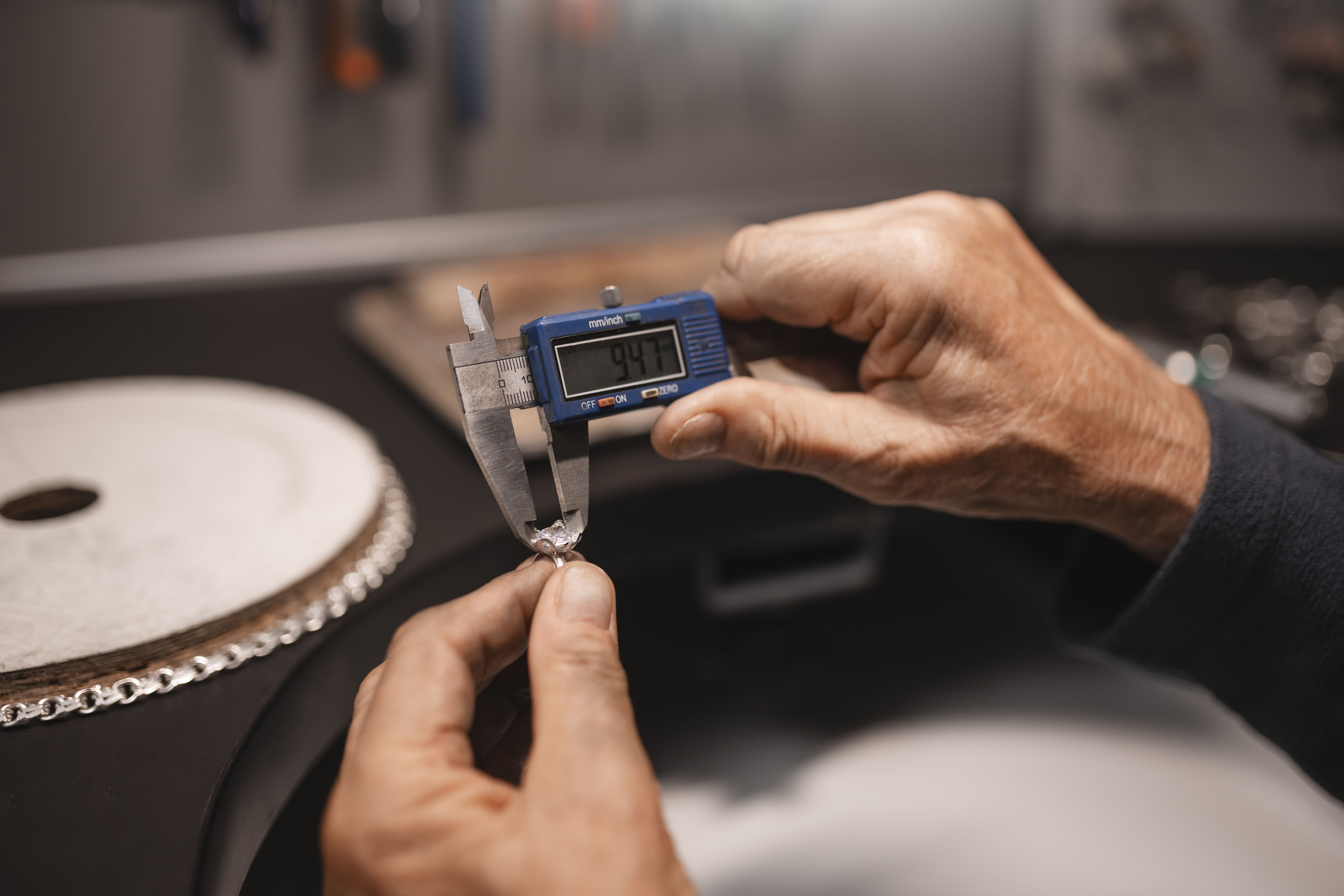 male-jeweler-working-shop-with-measuring-device.jpg