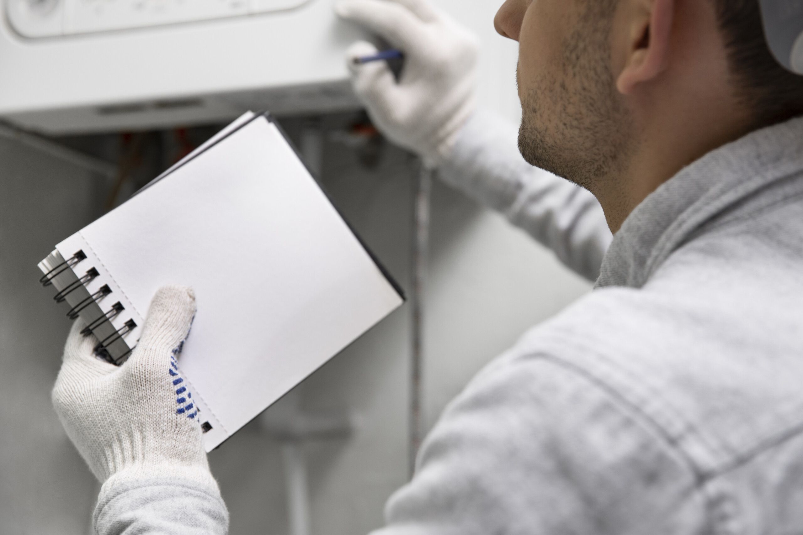 worker-repairing-water-heater-scaled.jpg